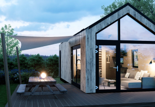 Moderne lodge Dordogne Deluxe bij La Draille in Frankrijk met grote ramen, houten terras en picknicktafel.