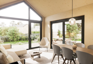 Lichte leef- en eetruimte in Dordogne Deluxe lodge bij La Draille, Frankrijk, met grote ramen en moderne inrichting.