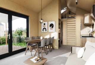 Licht en modern lodge-interieur bij Dordogne Deluxe, La Draille, Frankrijk met eet- en zithoek, en kitchenette.