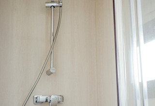 Shower in the bathroom of Houseboat Campi at Marina Uitgeest, Netherlands, modern and sleek style.
