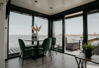 Interior view from Houseboat “Havenlodge Plus” at Marina Uitgeest, Netherlands, overlooking the water.