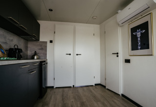 Modern kitchen and entrance area of Houseboat Havenlodge Plus at Marina Uitgeest, Netherlands, with stylish décor.