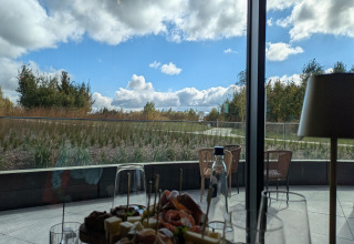 Uitzicht vanuit Chatillon 67 lodge in België, eten en drinken op tafel en natuur buiten het raam.