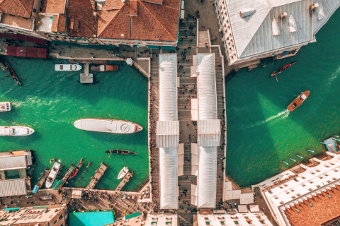Aerial view of a canal with boats and historic buildings near Cavallino, Veneto, Italy.