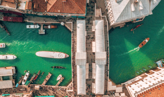 Aerial view of a canal with boats and historic buildings near Cavallino, Veneto, Italy.