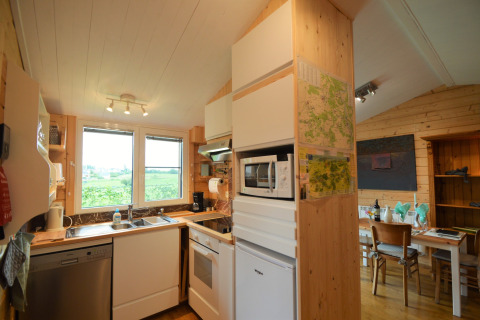 Cuisine et salle à manger en bois moderne au Chalet de Bioul, Belgique, avec fenêtres et vue.