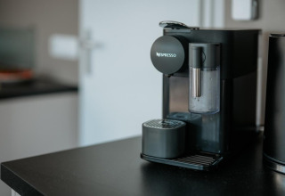 Nespresso coffee machine on a black counter in a modern kitchen of a houseboat in Zehdenick, Germany.