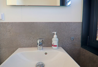 Bathroom sink with chrome faucet and soap dispenser on Houseboat ‘Family & Friends mit Hund LP 10’ in Germany.