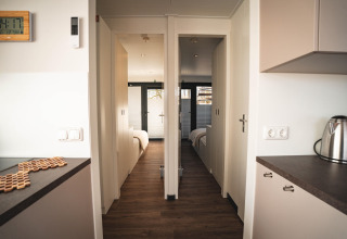 Modern interior of the Houseboat in Höxter, showing two bright bedrooms and minimalist kitchen space.