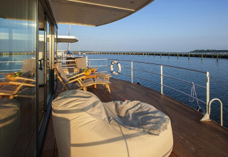 Hyggelig terrasse på husbåd med liggestole og udsigt over vandet, Houseboat Floating Houses Blue Active, Tyskland