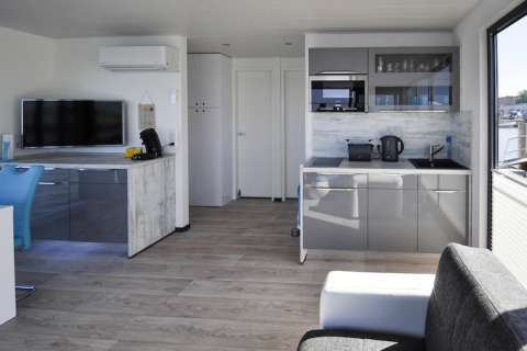 Modernes Wohnzimmer und Küche auf dem Hausboot Floating House 'Leni' in Ribnitz-Damgarten, Deutschland.