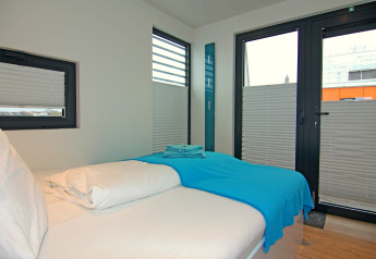 Modern bedroom on Houseboat 'Floating House Leni' in Ribnitz-Damgarten, Germany with single bed.