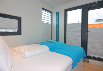 Modern bedroom on Houseboat 'Floating House Leni' in Ribnitz-Damgarten, Germany with single bed.