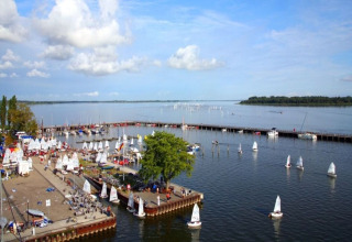 Overview of a marina with sailboats and a long pier on the water in Ribnitz-Damgarten, Germany.