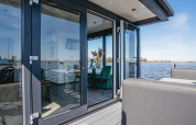 Houseboat moderno con porte in vetro e vista sull’acqua presso Marina Uitgeest, Paesi Bassi, Havenlodge Plus.