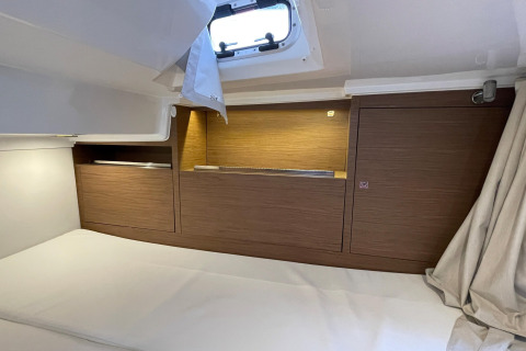 Sleeping area aboard houseboat Yacht Aquamarina in France, featuring wood paneling and overhead hatch.