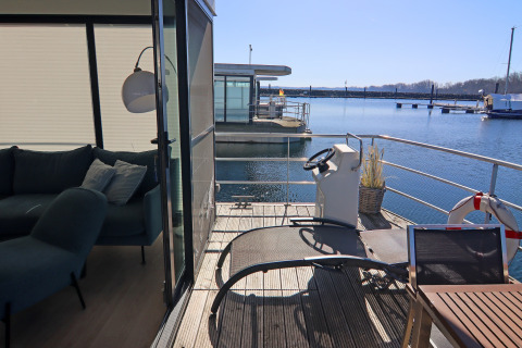 View from the living room and terrace of houseboat Family & Friends LP 4 in Germany with waterfront.