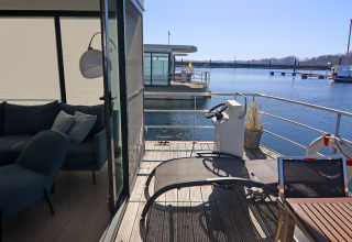 View from the living room and terrace of houseboat Family & Friends LP 4 in Germany with waterfront.