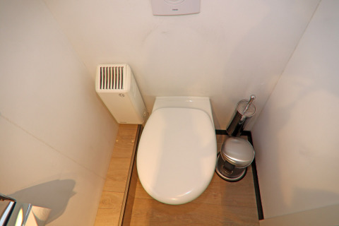 Modern houseboat toilet with wooden floor, heater and toilet set, top-down view on Family & Friends LP.