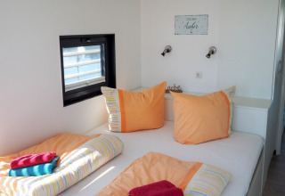 Bedroom on Houseboat Family & Friends LP 4 in Germany, with double bed and colorful linens.