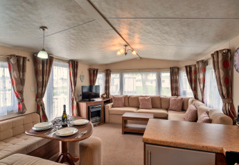 Helles Wohnzimmer im Phoenix Retreat Chalet mit großer Ecksofa, Esstisch und moderne Fensterdekoration.