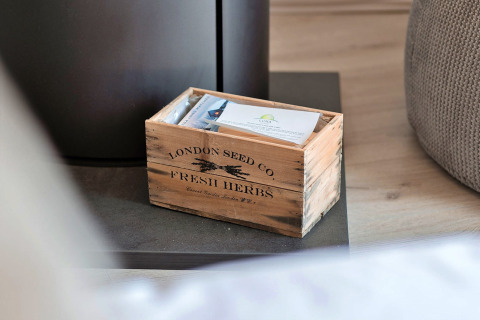 Wooden box labeled London Seed Co Fresh Herbs with packets inside at Ashdown Luxury Dome, United Kingdom.