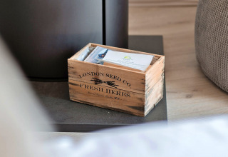 Wooden box labeled London Seed Co Fresh Herbs with packets inside at Ashdown Luxury Dome, United Kingdom.