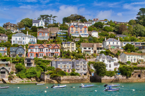 Maisons colorées sur la colline en bord de mer, avec petits bateaux, vues d'Oak Tree Lodge au Royaume-Uni.