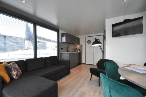 Modern living room and kitchen on houseboat 'Boat' in the Netherlands with large windows and decor.