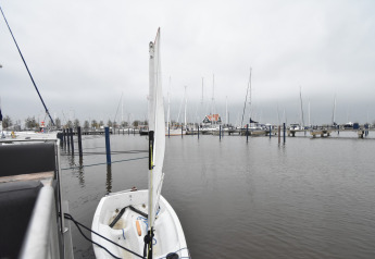 View from houseboat 'Boat' in the Netherlands showing a small docked boat and yachts in the marina.