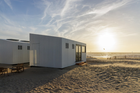 Moderne strandhytte ved solnedgang på Beach Houses Zandvoort 3, Zandvoort, Holland, med havudsigt.