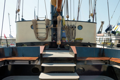 Banken op het dek van een woonboot in Leiden, dicht bij het stadscentrum en musea in de zon.