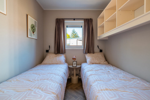 Twin beds in a cozy room at Groeneborg lodge with hot tub, Vakantiepark De Wiltzangh, Netherlands.