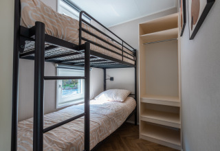 Bedroom with bunk beds and shelving at Groeneborg lodge with hot tub, Vakantiepark De Wiltzangh, Netherlands.