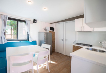 Cocina luminosa y comedor modernos en el Cottage Next para 1-5 personas en Vacanze Glamping Boutique, Italia.