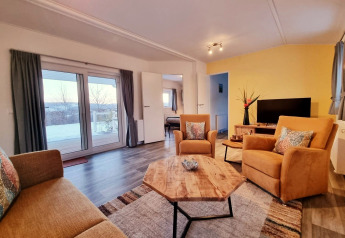 Bright and cozy living area at Chalet Limonet, Camping & Ferienpark Brilon, Germany, with modern furnishings.