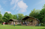 People relax and play near Avonturenlodge DeLuxe safari tents at Kampeerdorp de Zandstuve in the Netherlands.