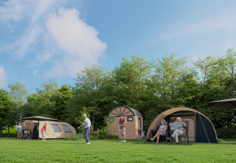 People enjoying a sunny day outside safari tents with private bathrooms at de Zandstuve in the Netherlands.