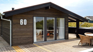 Moderne 6-personers feriebolig på Fanø med træterrasse, store vinduer og nummer 60 på facaden
