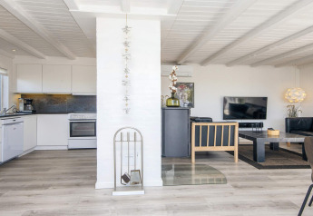 Modernes Wohn- und Küchenbereich in der Lodge 'Seaside Charm in Rindby' in Dänemark mit stilvoller, heller Einrichtung.