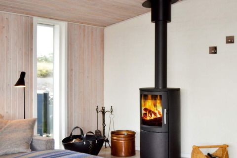Wohnzimmer im 6-Personen-Ferienhaus auf Fanø, Dänemark, mit Kaminofen und moderner Einrichtung.