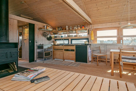 Lyst træinteriør i køkken og spisestue på feriehus til 4 personer i Bindslev, Danmark, med moderne faciliteter.