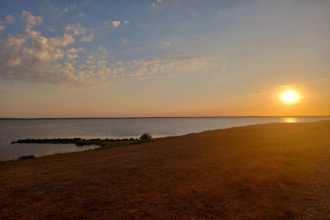 Sonnenuntergang am Wasser, gesehen von der Secluded Harbor Cottage in Dänemark, friedliche Naturstimmung.