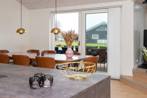 Dining area in 8 person holiday home in Sydals, Denmark, with modern decor and large glass doors.