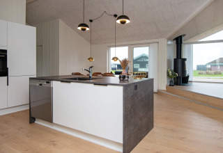 Modern kitchen with island at the 8-person holiday home in Sydals, Denmark, featuring bright, open space.