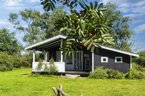 Charming black lodge with terrace in lush surroundings, 6 person holiday home in Glesborg, Denmark.