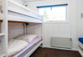 Room with bunk beds and a window at a 6 person holiday home in Glesborg, Denmark. Bright and cozy.