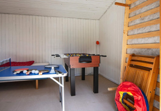 Game room at a holiday home in Glesborg, Denmark, with foosball, table tennis, and other activities.