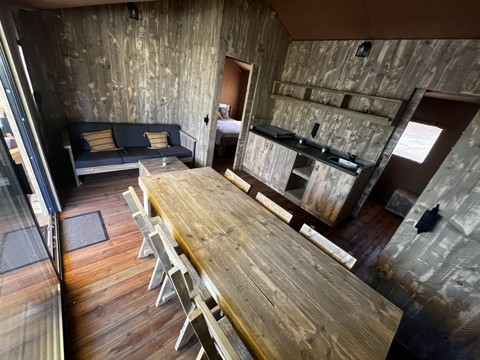Binnenaanzicht van de Luxury Lodge XXL safaritent op Camping Les Franquettes in Frankrijk, met houten interieur.