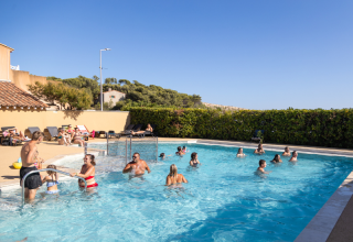 Swimming pool at Campsite Les Tamaris in Provence-Alpes-Côte d’Azur, France, with guests enjoying the water.